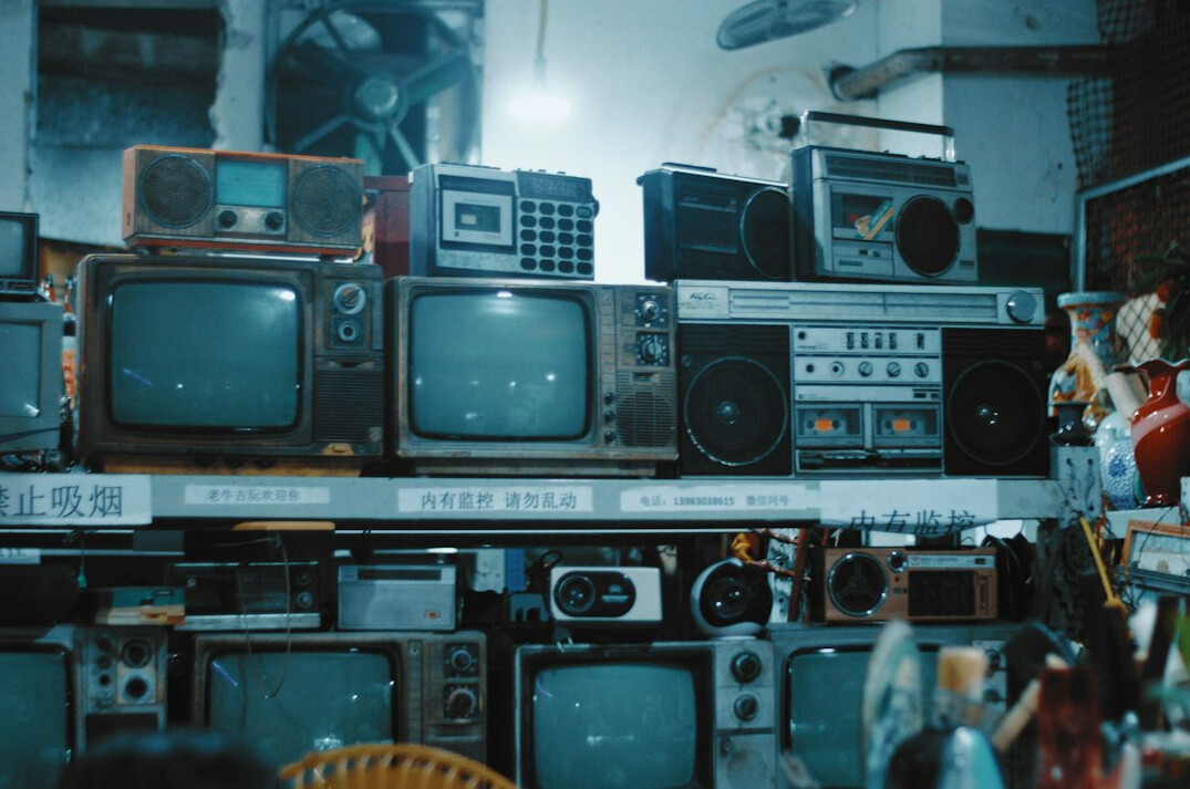 Vintage television broadcasting studio with analog cameras and colourful stage lights